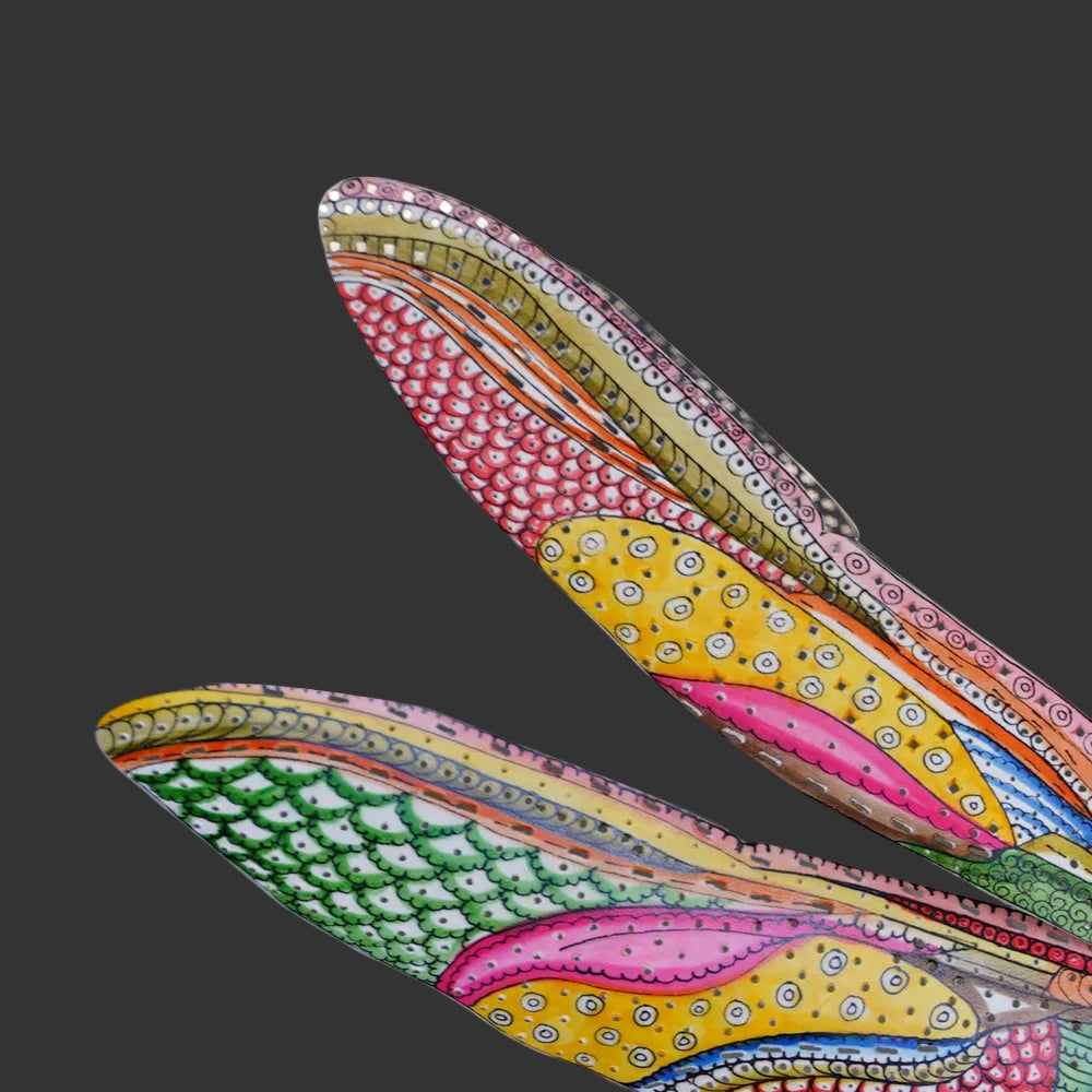 Close-up of the Tholu Dragonfly Wall Décor's hand-painted wings, showing detailed patterns against a white background.